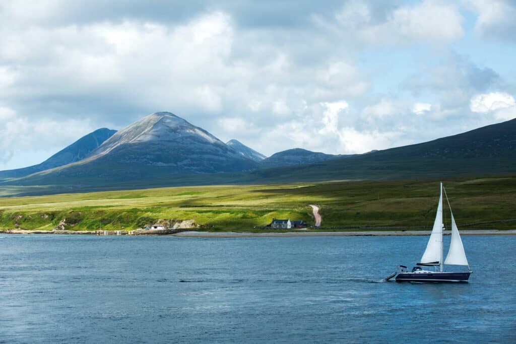 Sailing boat on a Scottish Lake with a mountain in the background